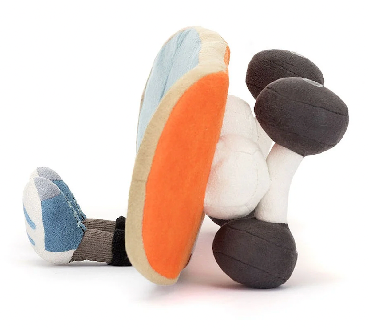 A plush toy in the shape of a skateboard. It has blue fabric with beige edging and orange details.