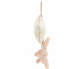 A plush blush pink bunny hanging from a star-shaped musical pull with a cream ribbon.