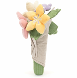 A plush toy bouquet of flowers with varied colors like pink, purple, and yellow, with a smiling face on the front and wrapped in a beige cloth.