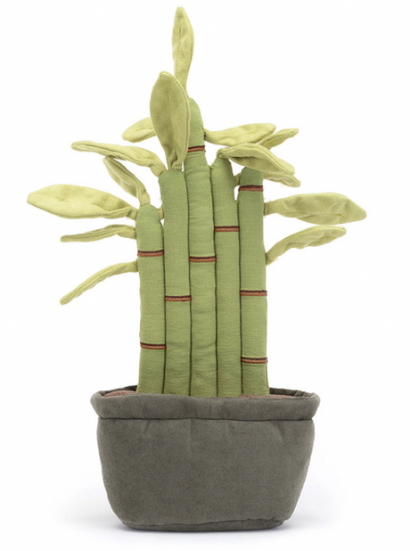 A plush toy resembling a potted bamboo plant with green leaves, red-brown stitch details, and a gray pot. The toy has fluffy soil at the bottom.
