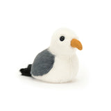 A plush toy resembling a seagull with soft fur in cream, grey, and black, and a suedette mustard beak.