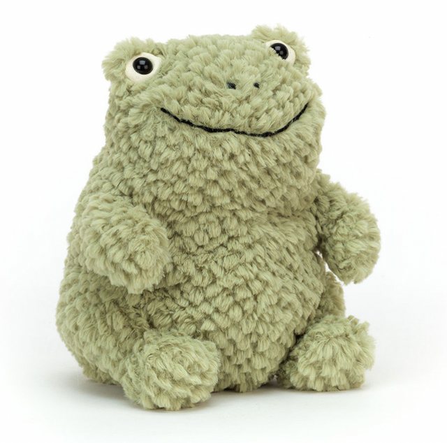 A plush toy resembling a green frog with a happy facial expression, made from a soft, textured fabric.