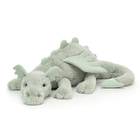 A soft toy depicting a sage green dragon with soft fur, sparkly wings, and a long tail.