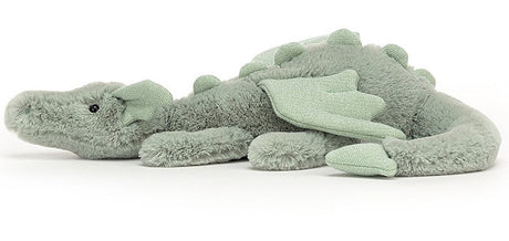 A soft toy depicting a sage green dragon with soft fur, sparkly wings, and a long tail.