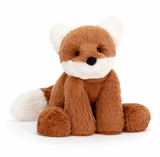 A plush toy representing a dark orange fox with fluffy cream ears and a tail, Sitting down on a plain background.