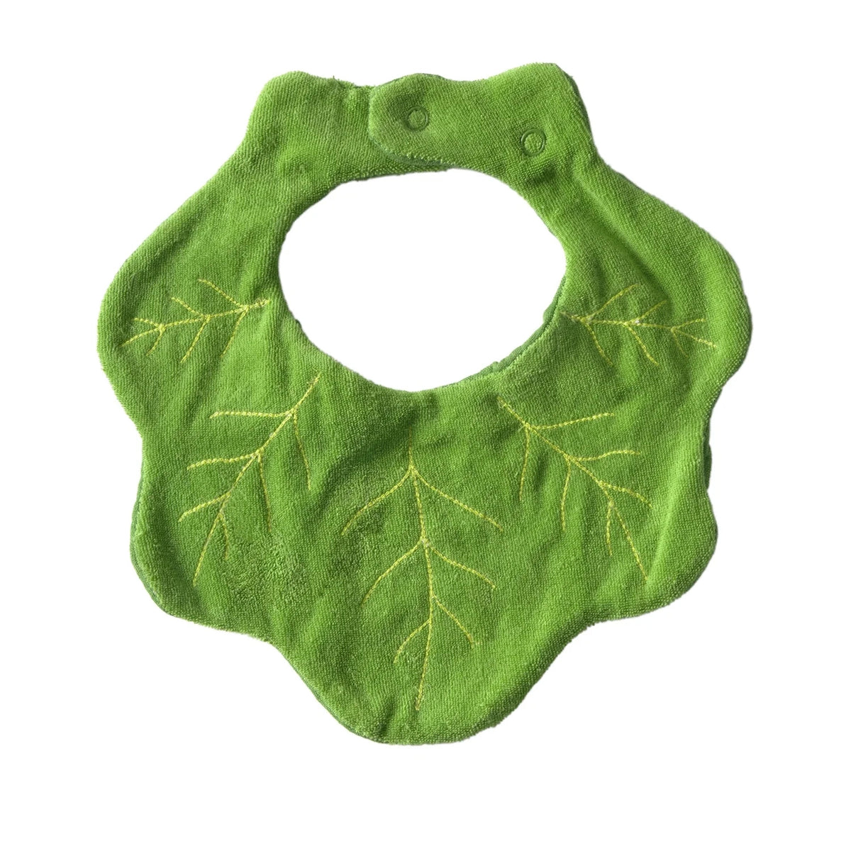 Reverse side of green baby bib with kale leaf patterns on a white background
