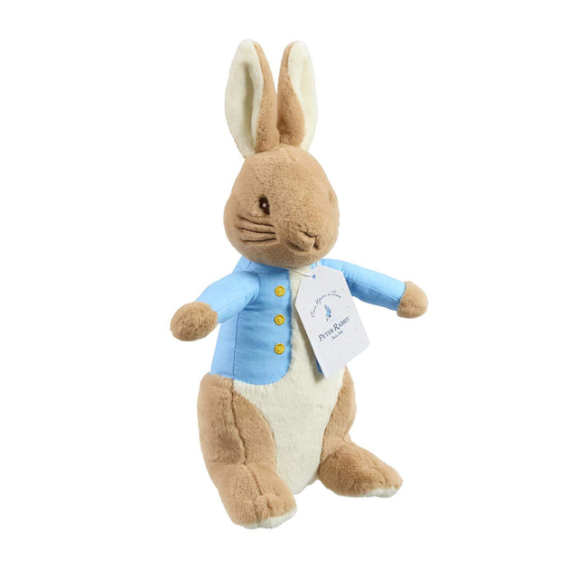 Peter Rabbit soft toy with bright blue waist coat and embroidered gold buttons and swing label tag on white background