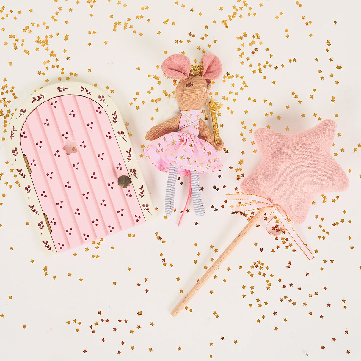 Pink fairy doll with a star wand and fairy door on a white background with gold confetti