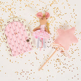 Pink fairy doll with a star wand and fairy door on a white background with gold confetti