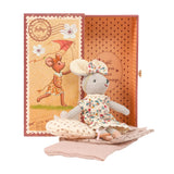 Stuffed cloth mouse toy in a floral dress and headband bow sitting on bedding with a matching open gift box