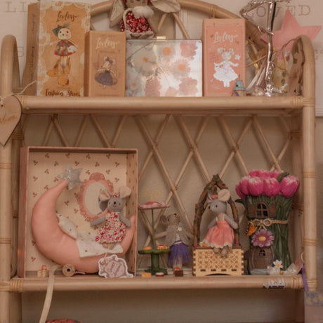 Decorative shelf with small figurines and boxes on a wooden shelf.