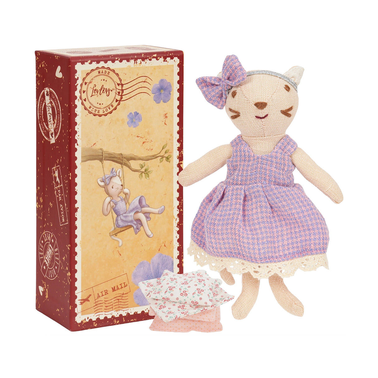Soft cat toy in a purple dress with a matching box on a white background