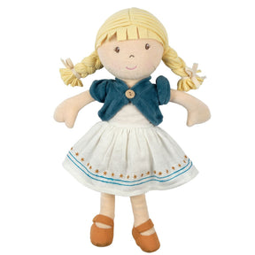 Toy soft doll with blonde pigtails wearing a white dress with blue trim and a blue cardigan on a white background