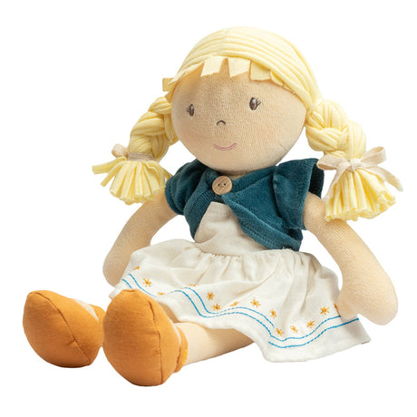 Soft rag doll with blonde hair, blue cardigan, and white dress on a white background