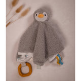 A grey penguin-shaped baby security blanket with a textured sherpa body, white belly, orange beak, and attached teething rings.