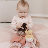 Baby playing with Little Duth Plush toy fairy dolls cuddle cloth with pink floral design