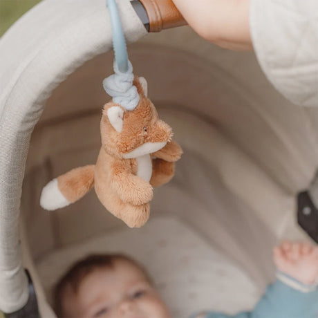 Little Dutch Pull and shake Plush fox toy hanging from a crib rail with a baby looking up at it.