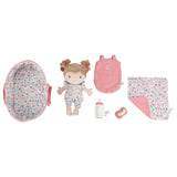 Baby doll and accessories set with floral and pink elements on a white background