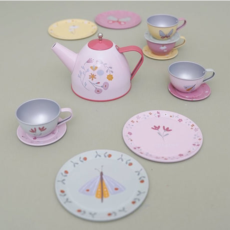 Children's tea set with pink teapot, cups, and saucers on a light gray surface.
