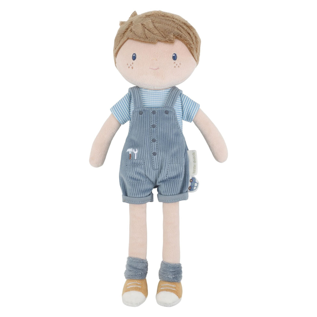Soft boy doll in blue overalls and a stripey blue t-shirt, blue socks and brown shoes.