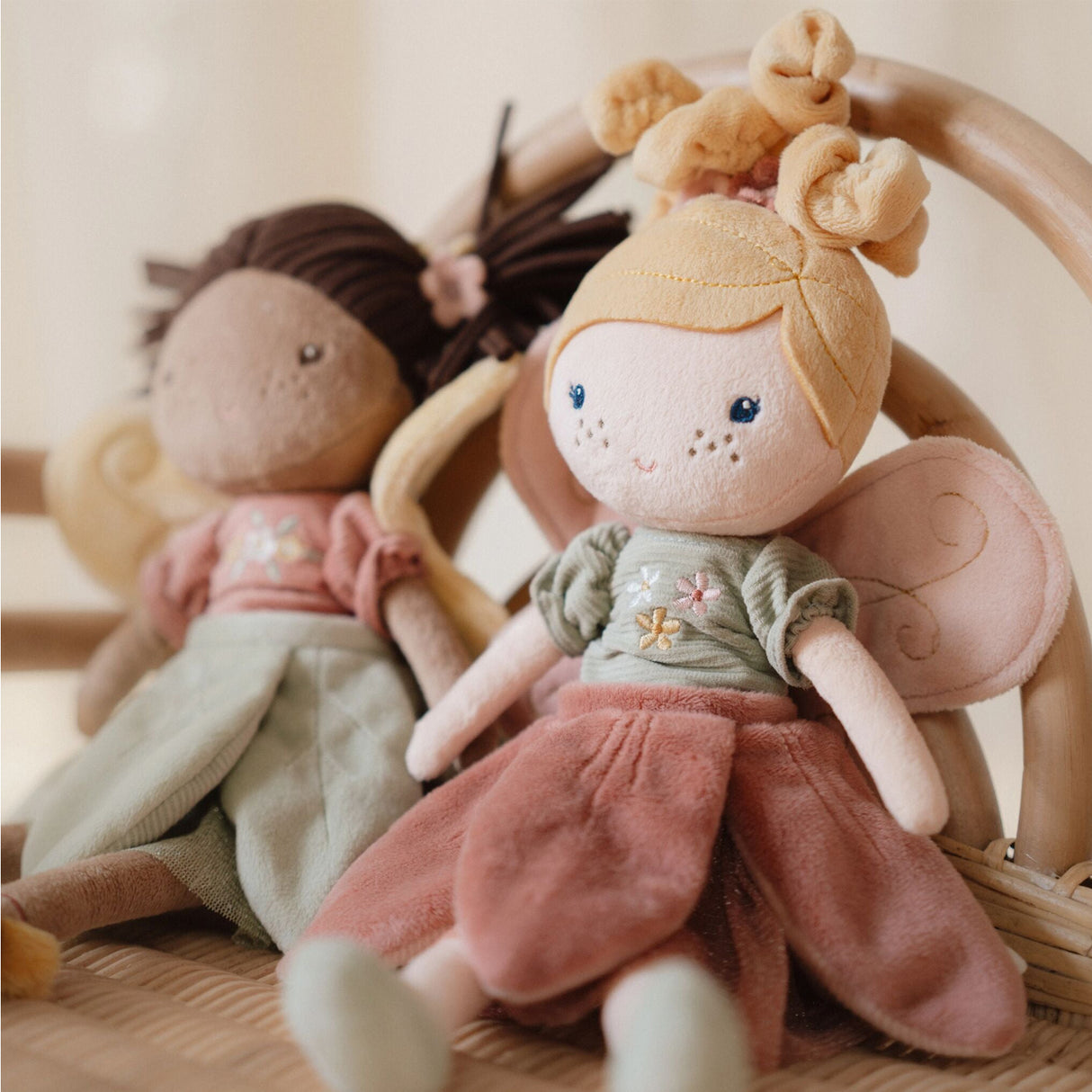 Little Dutch Fairy Mila and Fairy Evi cuddle dolls seated together in a wicker basket, lifestyle shot