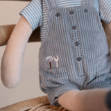Soft boy doll in blue corduroy overalls with embroidered tools in his pocket