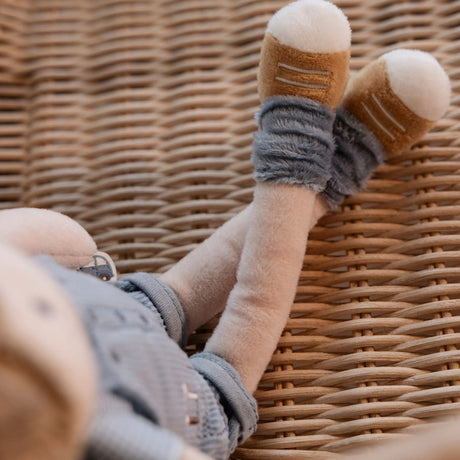 Male soft doll with blue fluffy socks and soft detailed brown shoes