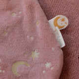 Pink fabric with star and moon patterns and a 'Little Dutch' tag.