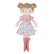 Little Dutch Hug Doll Rosa standing upright, with brown bun hairstyle, pink bows, embroidered floral T-shirt, floral skirt and pink pompom boots, on a white background