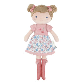 Little Dutch Hug Doll Rosa standing upright, with brown bun hairstyle, pink bows, embroidered floral T-shirt, floral skirt and pink pompom boots, on a white background