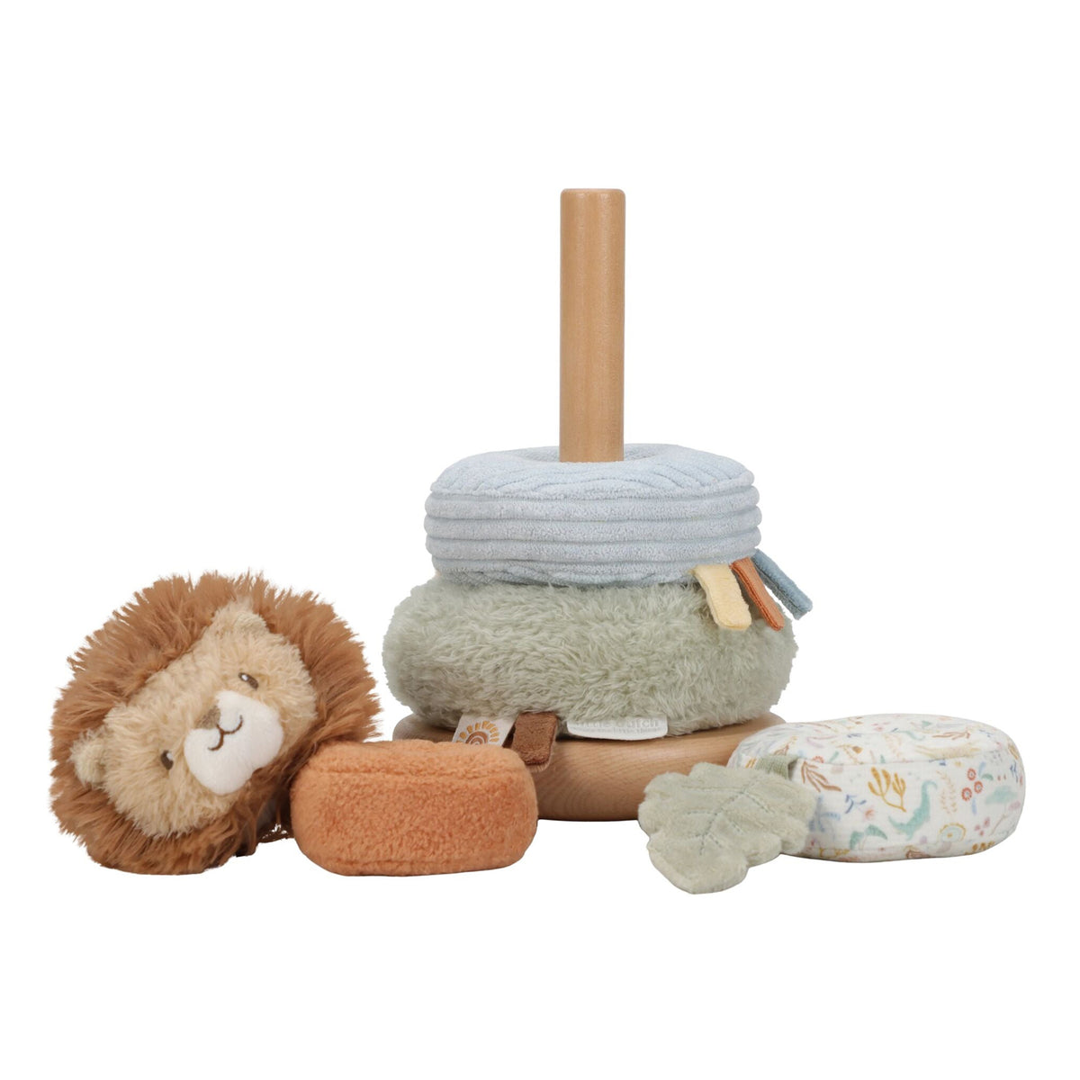 A soft fabric stacking toy set on a white background, featuring a wooden peg stick, light blue and sage green rings, a lion plush, a small orange plush piece, and a floral-patterned cushion.