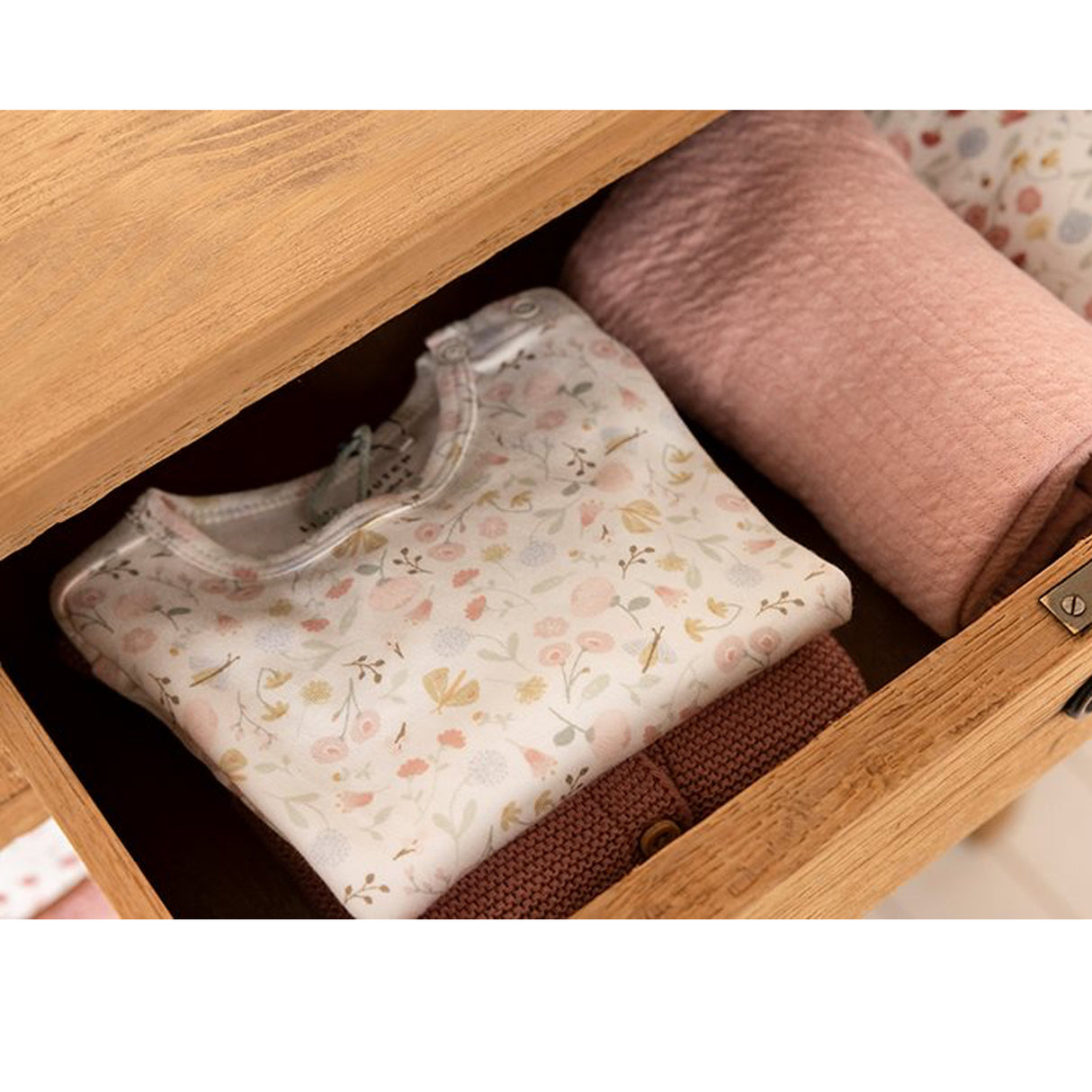 Little Dutch Flowers & Butterflies baby bodysuit folded in a wooden nursery drawer