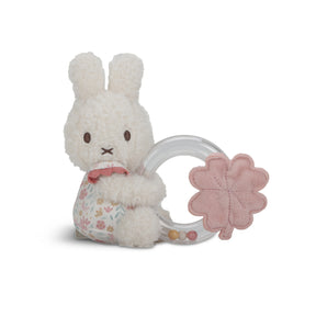 White Miffy plush bunny with a pink flower-shaped ring teether on a white background