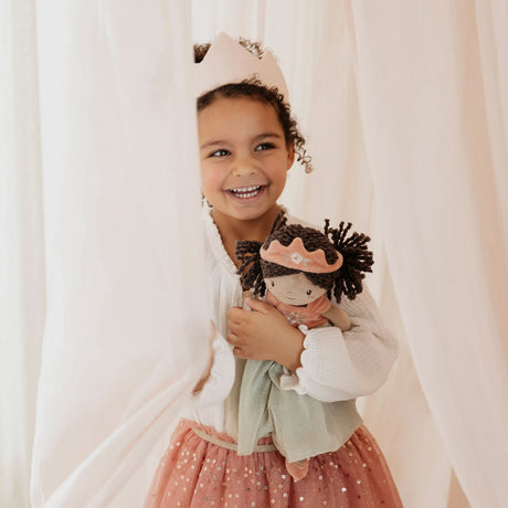 Girl holding Princess Evi Little Dutch doll and smiling - princess dress up play