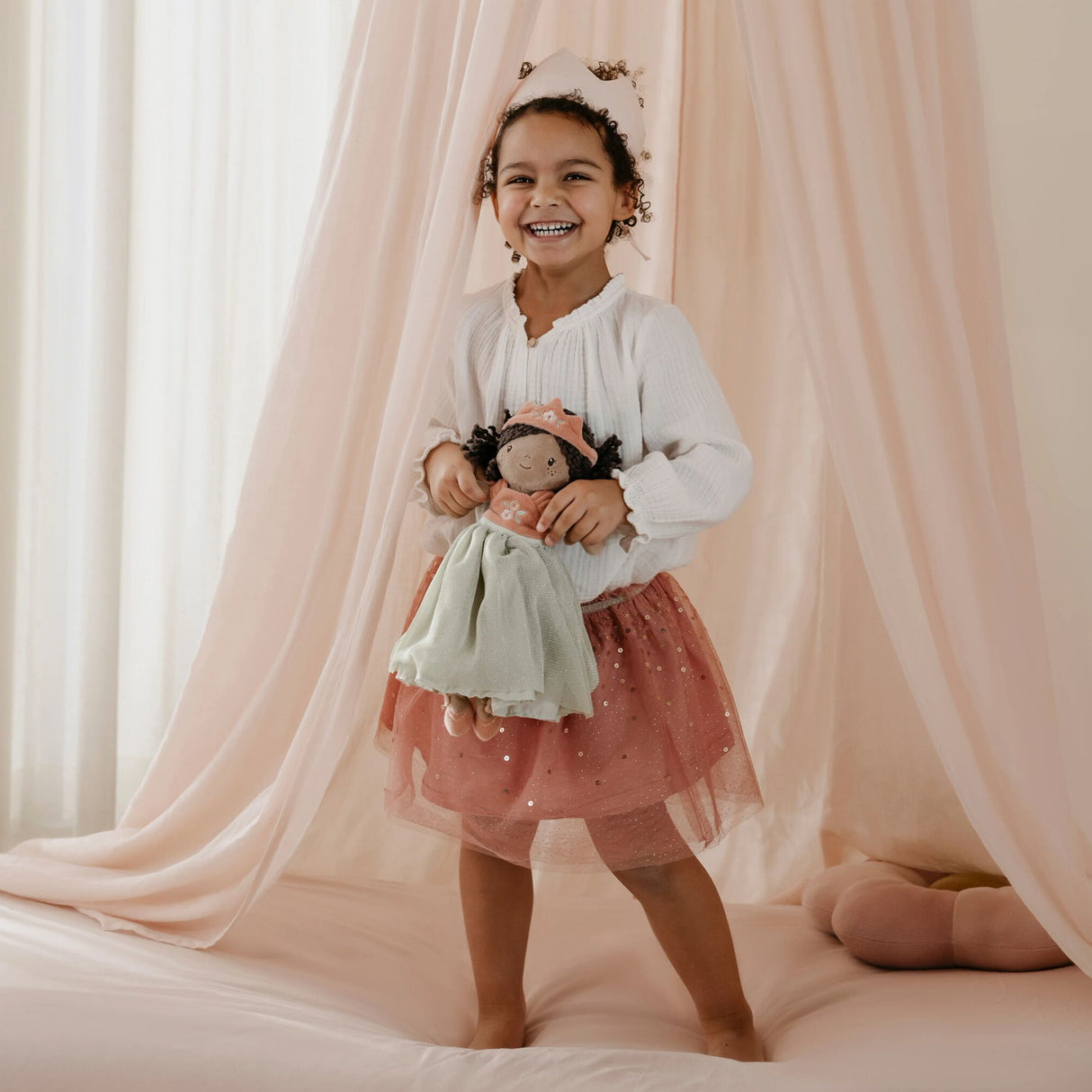Girl playing with Princess Evi Little Dutch doll under a canopy - imaginative play