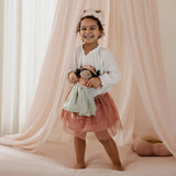 Girl playing with Princess Evi Little Dutch doll under a canopy - imaginative play