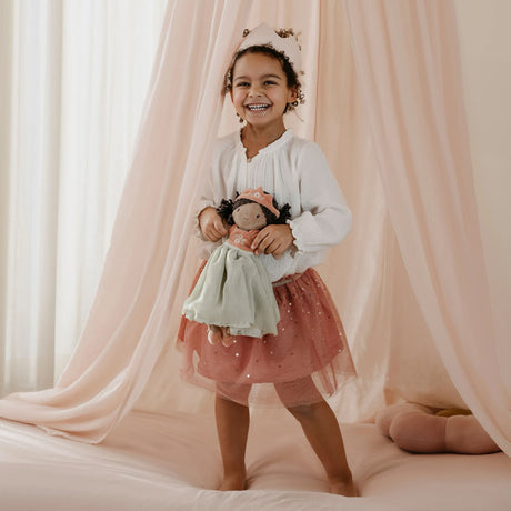 Girl playing with Princess Evi Little Dutch doll under a canopy - imaginative play