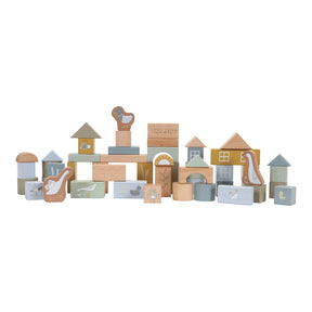 A collection of wooden building blocks in various shapes and sizes, decorated with ducks, birds and a frog. The blocks are in shades of blue, beige, and different colours. 