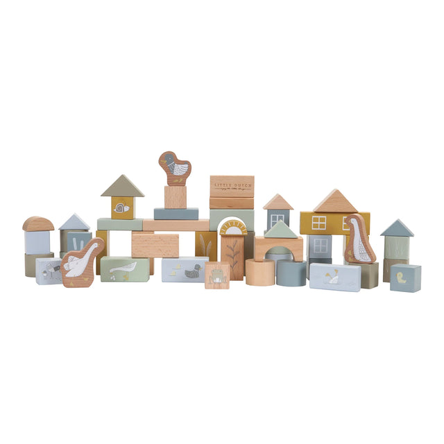 A collection of wooden building blocks in various shapes and sizes, decorated with ducks, birds and a frog. The blocks are in shades of blue, beige, and different colours. 