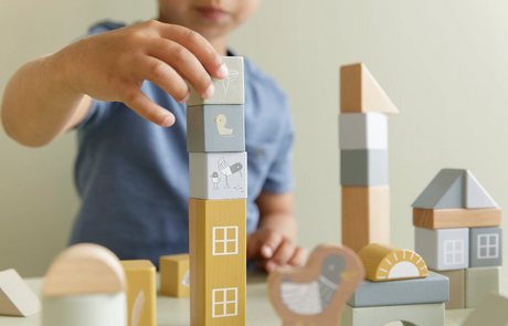 Stacked illustrated wooden building blocks in various colours