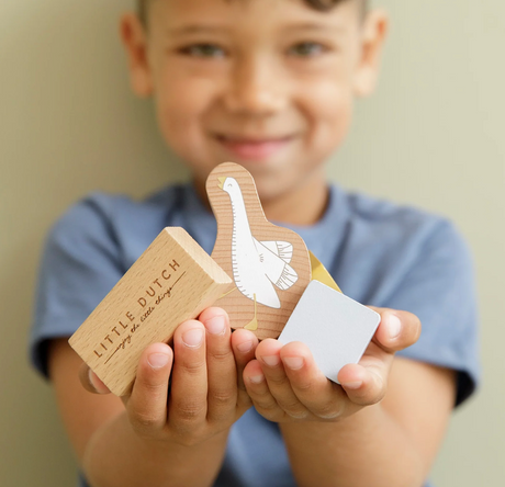 Little boy holding Little Dutch building blocks