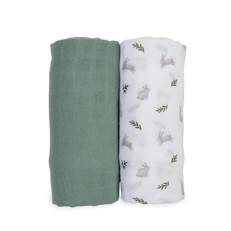 Two swaddle blankets, one green and one with rabbit and leaf pattern, on a white background