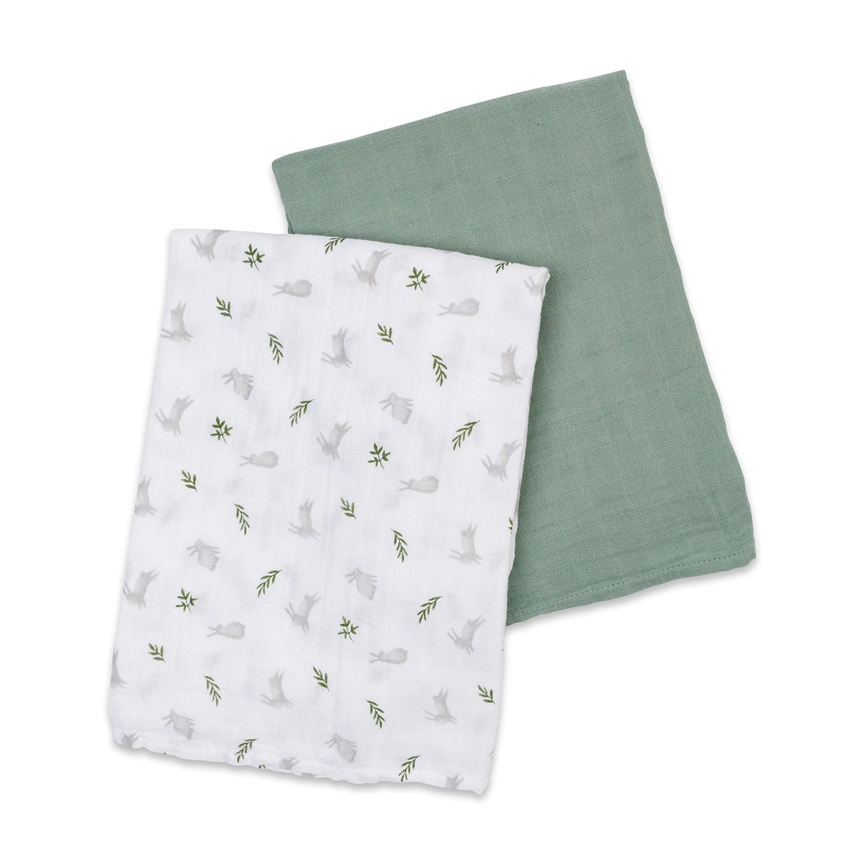 Two baby cotton swaddles, one white with a rabbit and leaf pattern and the other solid sage green, on a white background.