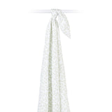Hanging white cotton muslin baby swaddle with green leaf pattern