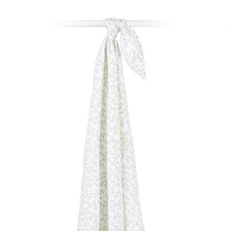 Hanging white cotton muslin baby swaddle with green leaf pattern