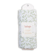 Packaged luLujo swaddle with leaf pattern on a white background