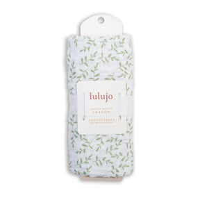 Packaged luLujo swaddle with leaf pattern on a white background