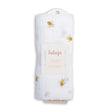 Lulujo baby swaddle with bee pattern and card with brand name on a white background