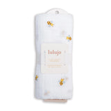 Lulujo baby swaddle with bee pattern and card with brand name on a white background