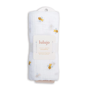 Lulujo baby swaddle with bee pattern and card with brand name on a white background
